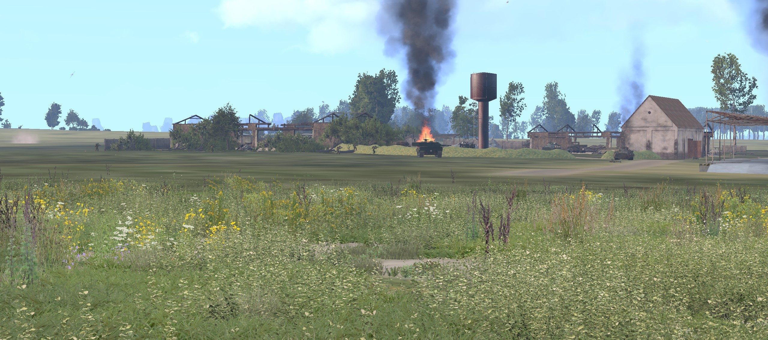 Burning wreck of a Russian BTR or BMP in the background as friendly tanks cover infantr (virtual Arma)